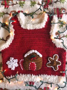 a crocheted christmas sweater with a gingerbread house on it