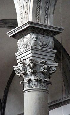 an ornate column in the middle of a building