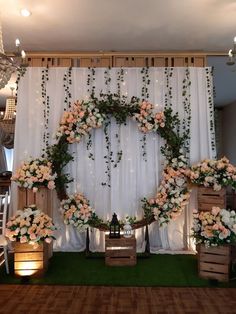 an arrangement of flowers and greenery decorates the backdrop for a wedding or reception