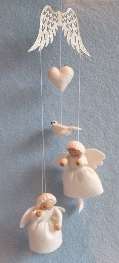 an angel mobile with two doves hanging from it's sides and hearts on the strings