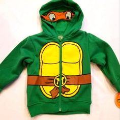 Teenage Mutant Ninja Turtles Hoodie Coat Jacket. Size 2t Cotton/Polyester Stylish Hoodie With Super Cute Tmnt Design On Front, Back And Hood. Hood Zip-Up Front For Easy Access Perfect For Dress-Up And Every Day Wear Machine Wash Cold; Officially Licensed Comes From A Pet And Smoke Free Home. School Cotton Hoodie, School Cotton Hoodie Outerwear, Cotton Hooded Jacket For Playtime In Fall, Fall Hooded Outerwear For Playtime, Playful Hoodie Outerwear For Winter, Playful Winter Hoodie Outerwear, Yellow Spring Hoodie Outerwear, Cotton Long Sleeve Outerwear For Play, Playful Cotton Outerwear For Streetwear