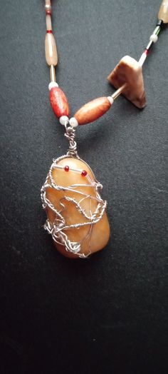 This is a brown jasper wire-wrapped pendant beaded long necklace. The brown jasper is associated with the root chakra, therefore, the metaphysical properties are associated with grounding, courage, and personal independence. The beads on the necklace are made of glass, rock, crystal, jasper, shell,  obsidian, and acrylic. The colors of the beads are shades of brown, red, silver, yellow and green.  Necklace Measurements:  Length: 32" Pendant Height: 2" Pendant Width: 1" If you have any questions or would like to see additional pictures, please do not hesitate to contact our shop. Thank you for your time. Personal Independence, Necklace Measurements, Brown Jasper, Chakra Racine, Shades Of Brown, Jasper Pendant, Root Chakra, Yellow And Green, Green Necklace