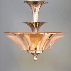 a chandelier hanging from the ceiling with three plates on it's sides