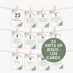 the 25 gifts of jesus - leds cards are hanging from clothes pins with green and red ribbons