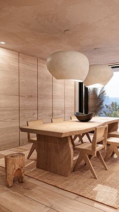 a dining room with wooden floors and large windows