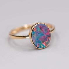 14K Yellow Gold Engagement Ring featuring an Oval Australian Doublet Opal. Free Domestic USPS First Class Shipping! Free One Year Limited Warranty! Free Gift Bag or Box with every order! Opal—the queen of gemstones, is one of the most beautiful and rarest gemstones on earth. Every piece of opals has its colors and patterns, which is perfect for designers to create unique engagement rings for someone extra special. We use 100% Natural & Ethically opal stones (NO synthetics or imitations) for our jewelry. ---------------------------------------------------------------ABOUT THIS PRODUCT14K Yellow Gold, Australian Doublet Opal, 1.15 ctMetal Color: GoldenOpal Color: Red, Yellow, Green & BlueRing Surface Measures: 11x9 MMRing Size: 7Occasion: Engagement/Birthday/Anniversary---------------------- Classic Oval Opal Ring With Polished Finish, Classic Oval Bezel Set Opal Ring, Classic Oval Opal Ring With Bezel Setting, Oval Opal Rings With Polished Finish, Fine Jewelry Oval Opal Ring With Polished Finish, Oval Opal Ring With Polished Finish In Fine Jewelry, Oval Opal Jewelry With Bezel Setting, Oval Opal Rings With Bezel Setting, Oval Opal Ring With Polished Finish For Wedding