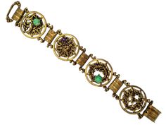 Rhinestone Bracelet, Ornate Bacchanalian Metalwork Faux Gemstone Bracelet!  This fun bracelet features super ornate metalwork that depicts a Bacchanalian theme. It has mottled green cabochons, a small faux pearl and a grape purple rhinestone. All are paste set in aged gold tone metal. Excellent vintage condition with expected plating wear. Measures 7 wearable inches long and 1 inch wide, closes with a hinged clasp. Ornate Cabochon Bracelet Jewelry, Gold Metal Bracelet With Cabochon, Ornate Cabochon Bracelet, Ornate Green Bracelet Jewelry, Gold Metal Bracelets With Cabochon, Victorian Green Bracelet Jewelry, Metal Cabochon Bracelet, Victorian Green Bracelets For Gifts, Antique Jeweled Metal Jewelry