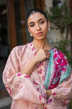 A blush pink cotton net kurta is adorned with scalloped embroidery along the neckline and sleeves and leaf motifs in a mulberry hue. A painterly printed mulberry hued medium silk dupatta is paired with a matching rawsilk trousers. Elegant Pink Palazzo Set With Printed Motifs, Pink Silk Anarkali Set With Printed Motifs, Pink Floral Embroidery Cotton Silk Sets, Unstitched Pink Silk Lawn Suit, Designer Pink Lawn Suit With Printed Motifs, Designer Pink Lawn Suit With Straight Kurta, Designer Pink Silk Lawn Suit, Pink Naqshi Kurta For Festive Occasions, Pink Bollywood Kurta With Naqshi Detailing