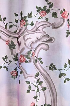 the curtain is decorated with pink roses and leaves on it's side, while an intricately designed design has been added to the fabric