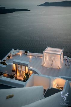 an aerial view of the roof of a house at night with lights shining on it