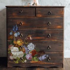 an old dresser with flowers painted on it