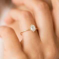 a woman's hand with a diamond ring on it