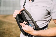 a man is holding an electronic device in his pocket