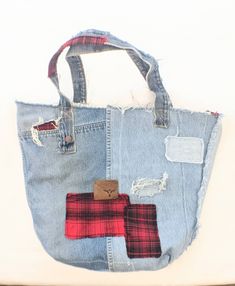 "These designer tote bags are as soft and comfortable as your best pair of boyfriend jeans paired with a big slouchy soft flannel. Constructed from worn and weathered sturdy jeans. They have been reinforced in all the right places. Perfectly distressed with pockets, holes, patches and leather labels. It's perfect for holding everything you need. With pockets inside and out to help keep you organized. Fresh cotton canvas lines the inside of the bag. With pockets and patches to make sure the insid Trendy Distressed Bag For Daily Use, Everyday Distressed Denim Bag, Casual Distressed Bags For Daily Use, Trendy Upcycled Tote Bag, Everyday Distressed Tote Bag, Casual Upcycled Bags From Recycled Denim, Casual Upcycled Bags Made Of Recycled Denim, Casual Upcycled Bags Made From Recycled Denim, Casual Upcycled Recycled Denim Bags