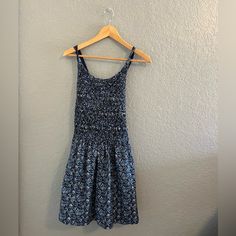 Nwt Free People | Petunia Cotton Mini Dress In Blue Floral Smocked Overall Style, Size S So Sweet In An Apron-Style Silhouette, This Essential Mini Dress Features A Textured Top Piecing With Cross-Straps At Back For Added Dimension. Beautiful Blue Cottage Core Vibes With Little White Flower Print. Features: Button Closure At Straps Side Pockets Scoop Neckline Care/Import Machine Wash Cold Inside Out 100% Cotton Measurements For Size Small Bust: 30 In Length: 30.5 In Size: Women's Small Color: Bl Casual Cotton Dresses With Gathered Waist, Casual Cotton Dress With Smocked Back, Cotton Smocked Dress With Floral Print For Beach, Casual Beach Sundress With Stretch, Casual Stretch Beach Sundress, Casual Stretch Sundress For Beach, Fitted Cotton Sundress With Smocked Back, Beach Smocked Cotton Dress, Summer Fitted Sundress With Gathered Waist