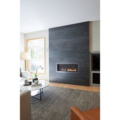 a modern living room with fireplace and couches