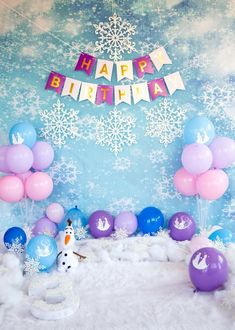 a birthday party with balloons and snowflakes