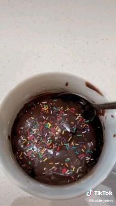 chocolate donut in a mug with sprinkles on top and the words chocolate donut in a mug above it