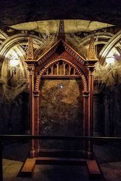 an ornate wooden structure in the middle of a room