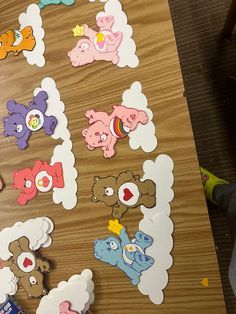 there are many stickers on the table with different shapes and sizes, including teddy bears