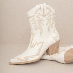 Southwestern flair covers this cowboy boot in a gorgeous stitch pattern with thread toned to match.Shaft Height: 7.5"Heel Height: 2.5"Types of Closures: Slip onCircumference of Shoe Opening: 13"Shaft circumference:12" White Western Boots For Western-themed Events, Western Cream Ankle Boots, Western Style Cream Ankle Boots, Western Mid-calf Boots With Pointed Toe For Rodeo, White Western Boots For Country Events, Western Style Pointed Toe Mid-calf Boots For Rodeo, Bohemian White Boots For Fall, Western Cream Snip Toe Heeled Boots, Western Cream Heeled Boots With Snip Toe