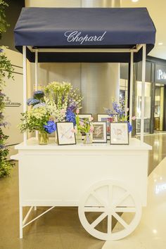 a white cart with flowers and pictures on it