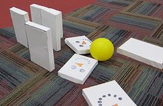 several pieces of paper are laying on the floor next to a yellow ball and two white doors