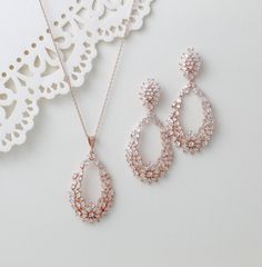 This rose gold necklace and earring set is perfect for special occasions. Featuring a sophisticated hoop style design, the set is adorned with sparkling cubic zirconia stones, making it a stunning choice for bridal jewelry. Elevate any outfit with this elegant and timeless set. Earrings measure 2.25" x 1" Necklace length 16 inches extends to 18 inches Pendant measures 2" x 1.125" Matching bracelets: https://www.etsy.com/listing/489107525/bridal-tennis-bracelet-rose-gold?click_key=59aaaf3f952d0eba017a1664c344288c5ffb87f9%3A489107525&click_sum=226dd81d&ref=shop_home_active_1&pro=1&frs=1&sts=1 https://www.etsy.com/listing/549791929/rose-gold-bridal-bracelet-bridal-jewelry?click_key=37d173e3ab72e0ebfa1174d7e8256fc27a90cef2%3A549791929&click_sum=1a44da13&ref=shop_home_active_4&pro=1&frs=1&sts=1 Rose Gold Jewelry Set, Wedding Rose Gold, Jewelry For Wedding, Pink Jewelry Set, Gold Jewelry Set, Rose Gold Bridal Earrings, Rose Gold Hoop Earrings, Wedding Rose, Bracelet Rose Gold