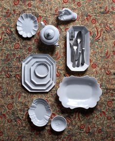 a table set with plates, silverware and utensils on top of it