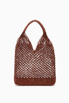 An exquisite display of artisanal craft, our Tulia Hobo is skillfully hand-woven from leather in India using an intricate macramé technique. It opens to an unlined, roomy interior that easily fits your essentials and has shoulder straps with leather weaving for comfortable wear. This sumptuous brown silhouette is tightly woven at the base, ensuring your belongings stay secure. Each piece is beautifully unique due to its handmade nature. Composition: 100% Calf Leather Style with our Diana Pullove Luxury Leather Hobo Bag With Intrecciato Weave, Nyc Boutiques, Leather Weaving, Leather Hobo Bag, Hobo Handbags, Large Bag, Leather Hobo, Ulla Johnson, Leather Tote Bag