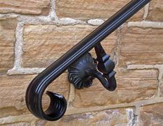 an iron hook on the side of a brick wall