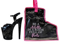 a pair of black high heeled shoes next to a bag with pink trimmings