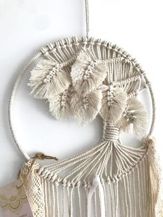 a macrame hanging on the wall with tassels attached to it's sides