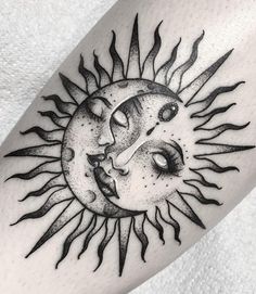 a sun and moon tattoo on the arm