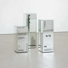 three clear boxes sitting on top of a floor