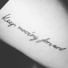 a woman's arm with the words keep moving forward written in cursive font