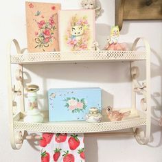 two shelves with cards and toys on them