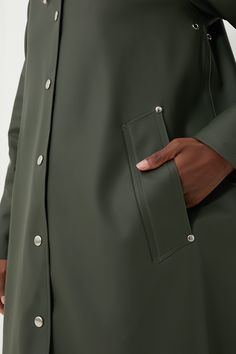 Inspired by the quality and feel of his grandfather's old raincoat, Alexander Stutterheim set out to re-produce a modern version of this classic. Designed in Stockholm, made in Europe- each raincoat is handmade from 100% rainproof rubberized cotton and produced by dedicated Stutterheim seamstress. Each one is numbered and signed by its creator, making each coat as unique as the other.With feminine style in an A-line silhouette, the Green Mosebacke Jacket is still your go-to, year-round raincoat. Classic Solid Raincoat With Pockets, Long Raincoat With Button Closure, Fall Raincoat For Rainy Weather, Fall Raincoat With Button Closure For Rainy Weather, Classic Outerwear For Rainy Season, Classic Solid Waterproof Raincoat, Classic Outdoor Raincoat, Classic Waterproof Raincoat For Fall, Classic Waterproof Solid Color Raincoat