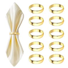 a set of six gold wedding rings and napkins on a white background with a bow tie