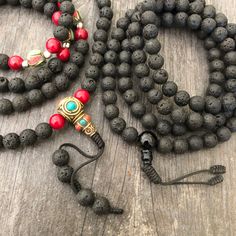 Everyday black lava stone mala necklace. You can choose between 2 styles. 1- A Mala necklace that is all black lava stones which is 43cm- 17 inch long (there is no clasp, you wear it over the head) 2-A Mala necklace which has black lava stones, red beads and unique Nepali beads. This Mala is 48cm- 19 inch long ( there is no clasp, you wear it over your head) This unique unisex mala necklaces can be a diffuser necklaces also, as you can choose which ever oil that you like to use with the lava roc Holistic Black Round Beaded Jewelry, Holistic Black Round Beads Jewelry, Spiritual Black Natural Stone Beads, Handmade Black Mala As Gift, Adjustable Black Mala With Round Beads, Black Natural Stones Beads For Meditation, Black Mala With Round Beads For Gift, Black Mala With Round Beads, Adjustable Black Spiritual Mala