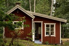 a small red cabin in the woods