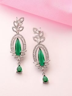 Teardrop Shaped Drop Earrings, Green AD Stone Studded, Silver Plated Earing Main Stone: AD Stone Stone Cut : Round Color : Green And Silver Metal: Brass Size & Fit: Length of Earring: 6 CM Material & Care: Brass and American Diamond Wipe with a clean cotton swab when needed Elevate your elegance with these exquisite silver AD-studded teardrop-shaped earrings. Crafted for the modern woman, these earrings feature a delicate teardrop design, adorned with shimmering American Diamonds (AD) that catch Argentium Silver Jewelry, Subtle Luxury, Green And Silver, Round Sapphire, Cotton Swab, Clean Cotton, Earrings Green, Argentium Silver, Stone Studs