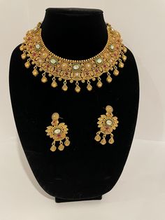 Indian Gold color art jewellery set.  Adjustable Maharani necklace with a pair of matching earrings. Formal Jewelry Sets With Matching Earrings, Formal Jewelry Sets With Matching Earrings For Festivals, Handmade Temple Jewelry For Party, Artistic Choker Jewelry As A Gift, Artistic Choker Jewelry For Gifts, Elegant Festive Jewelry With Artistic Design, Artistic Choker Jewelry Gift, Elegant Multicolor Pendant Jewelry Sets, Artistic Gold Jewelry For Wedding