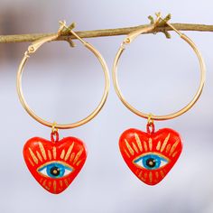 Full of love and passion, these 14k gold-plated hoop earrings are a romantic creation handcrafted by Mexico's Edith Orozco. The centerpieces are hearts made from papier mache, with intense eyes painted over, symbolizing desire. Small Hoop Heart Earrings For Valentine's Day Gift, Valentine's Day Small Hoop Heart Earrings As Gift, Valentine's Day Gift Small Hoop Heart Earrings, Valentine's Day Gift Heart Hoop Earrings, Symbolic Hoop Earrings As Gift, Vibrant Handmade Gold Earrings, Hoop Earrings For Valentine's Day Gift, Valentine's Day Gift Hoop Earrings, Open Heart Hoop Earrings For Gifts