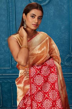 Look your best at weddings and festive occasions in this beautiful golden Banarasi saree with red zari border. It comes with a matching blouse piece. Disclaimer: The shown stitched blouse on the model is for display purpose only. The saree comes with a matching blouse piece and finished with fall and piko. Transitional Gold Banarasi Silk Pre-draped Saree, Traditional Gold Pre-draped Saree For Navratri, Gold Paithani Silk Pre-draped Saree, Traditional Gold Paithani Silk Pre-draped Saree, Gold Pre-draped Paithani Silk Saree For Festivals, Traditional Gold Pre-draped Saree With Self Design, Gold Tussar Silk Pre-draped Saree With Zari Weaving, Transitional Gold Pre-draped Saree, Red Handloom Tissue Silk Blouse Piece