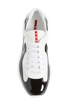 Modern mesh inlays add a touch of texture to a sporty sneaker formed from high-shine patent leather. Removable insole. Leather and textile upper and lining/rubber sole. By Prada; Made in Italy Men's Shoes.