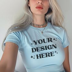 🌟 Light Blue Baby Tee Mockup 🌟 Bring your designs to the next level with this trendy Y2K aesthetic Baby Tee Mockup! ✨  📸 Mockup Details: * High-Quality Image: Crisp and clear to make your designs pop. * Gildan 5000B: Styled as a Y2K baby tee on women, capturing that iconic 90s look. 💖 Why You'll Love It: * Y2K Aesthetic: Perfect for capturing that trendy Y2K vibe * High Quality: Crisp, clear, high quality images that make your designs pop. * Easy to Use: Perfect for Canva, Photoshop, or any Fitted Light Blue T-shirt With Letter Print, Blue Tops With Custom Print For Streetwear, Blue Custom Print Crew Neck Tops, Blue Tops With Custom Print And Crew Neck, Blue Crew Neck Top With Custom Print, Customizable Blue Crew Neck Shirt, Customizable Fitted Blue T-shirt, Customizable Blue Short Sleeve T-shirt, Fitted Blue Customizable T-shirt