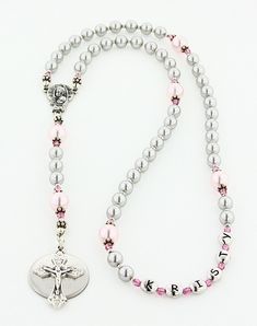 "This Girls Baptism Rosary is a beautiful baptism or christening gift. It is available with or without a Name in the 3rd decade and with or without an Engraved Disc. This grey and pink rosary is made with all Genuine Swarovski Pearls and Swarovski Crystals. It comes with your choice of a gift message that is elegantly boxed for simple gift giving. Add a Name in Beads - Select a name option. - Enter a name that is 10 characters or less. The name will be placed in the 3rd decade. Add an Engraved D Adjustable Pink Rosary Bracelet For First Communion, Pink Rosary With Round Beads For First Communion, Pink Rosary For First Communion, Adjustable Silver Rosary For Mother's Day, Personalized Adjustable Rosary With Round Beads, Adjustable Pink Cross Rosary, Pink 8mm Beads Crucifix Jewelry, Pink Rosary, Personalized Rosary