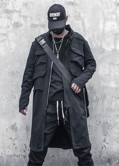 Discover the Techwear Long Coat - the epitome of style and innovation for the modern urban dweller. Imagine walking down the city streets, commanding attention from everyone around you. The Techwear Long Coat exudes a futuristic and intimidating aura that will leave a lasting impression on anyone who sees you. With its oversized silhouette, this coat is perfect for those who want to stand out. This black, oversize coat is designed with Japanese streetwear in mind and is the perfect addition to any fashion-forward wardrobe. Not only is this coat stylish, but it is also practical. With four big cargo pockets on the front and two large pockets with straps on the back, you'll have plenty of space to store your essentials. The tactical and technical aspect of the garment adds to its unique desi Cloak Black, Spring Windbreaker, Cargo Jacket Mens, Techwear Jacket, Apocalyptic Clothing, Tactical Jacket, Streetwear Hip Hop, Clothing Streetwear, Langer Mantel