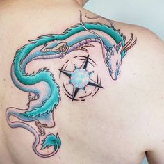 the back of a woman's shoulder with a blue dragon tattoo on her chest